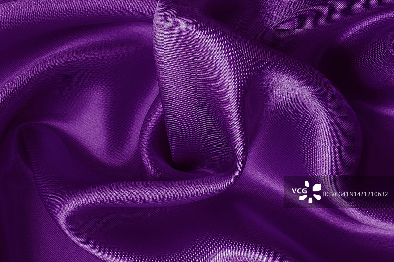 紫色织物作为背景布的纹理和设计艺术作品，美丽的褶皱图案的丝绸或亚麻。图片素材