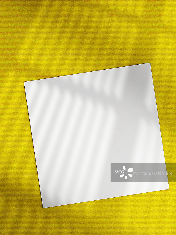 纸空白模板。在黄色的表面投下阴影图片素材