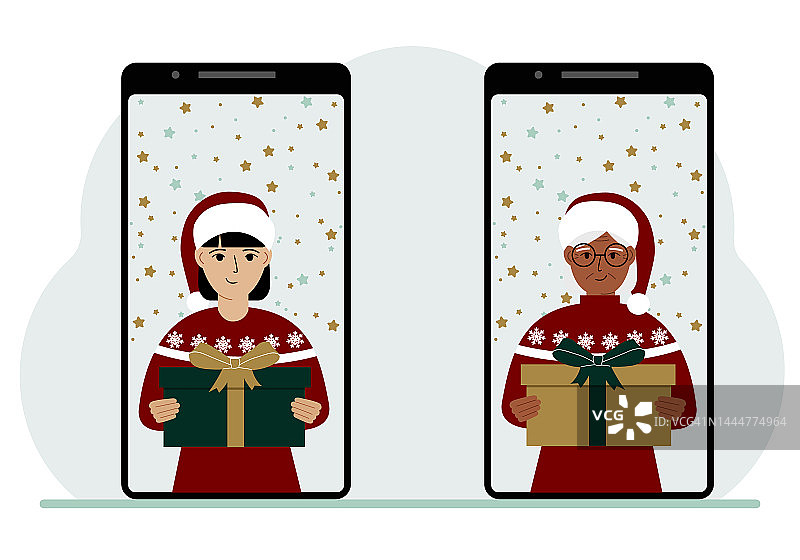 一名女子和另一名女子通过手机视频会议在网上见面，虚拟讨论圣诞和新年假期和礼物。图片素材