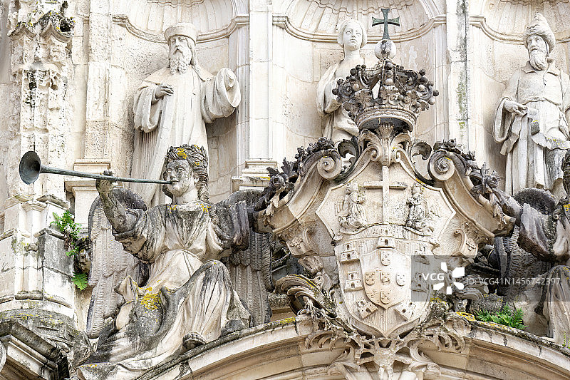 天使、圣徒和国王的雕像竖立在科英布拉古圣十字架教堂的正面图片素材