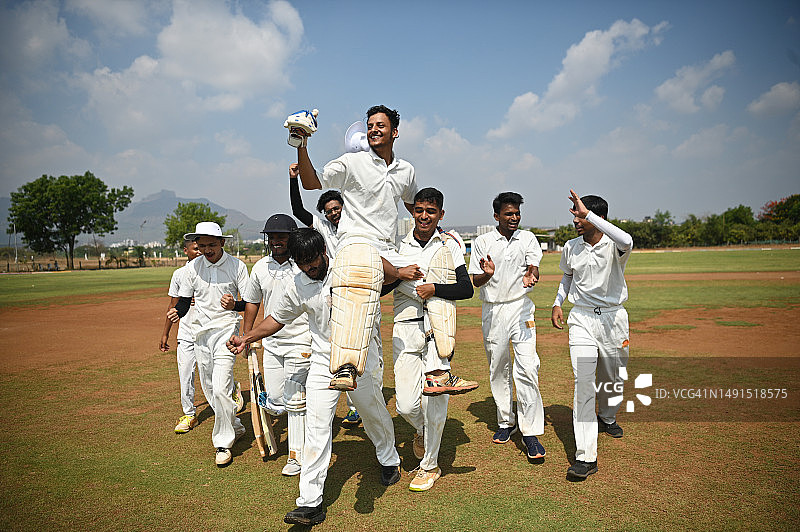 队员们把击球手举在肩上，表现出赢得板球比赛后的胜利感图片素材