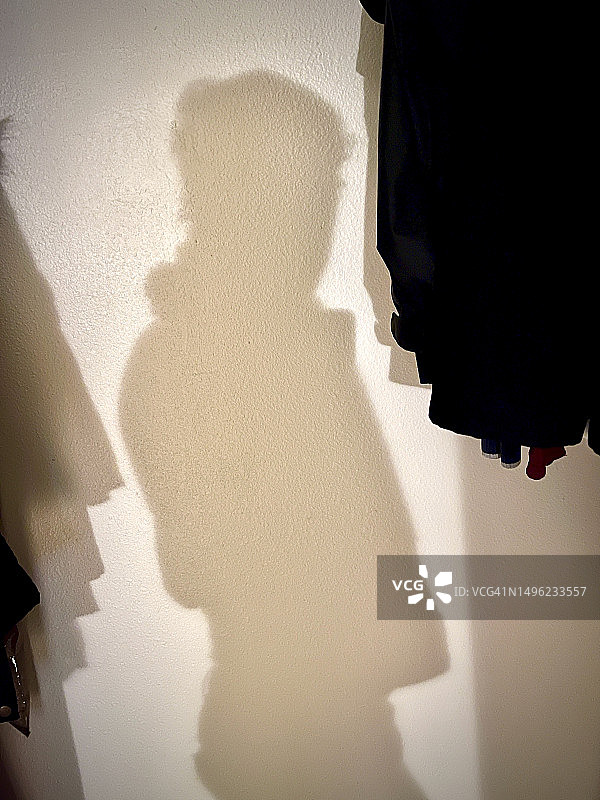 一个人在衣帽间里穿衣服的影子图片素材