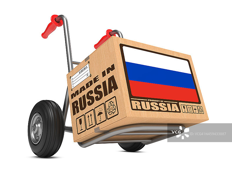 俄罗斯制造-手推车上的纸箱。图片素材