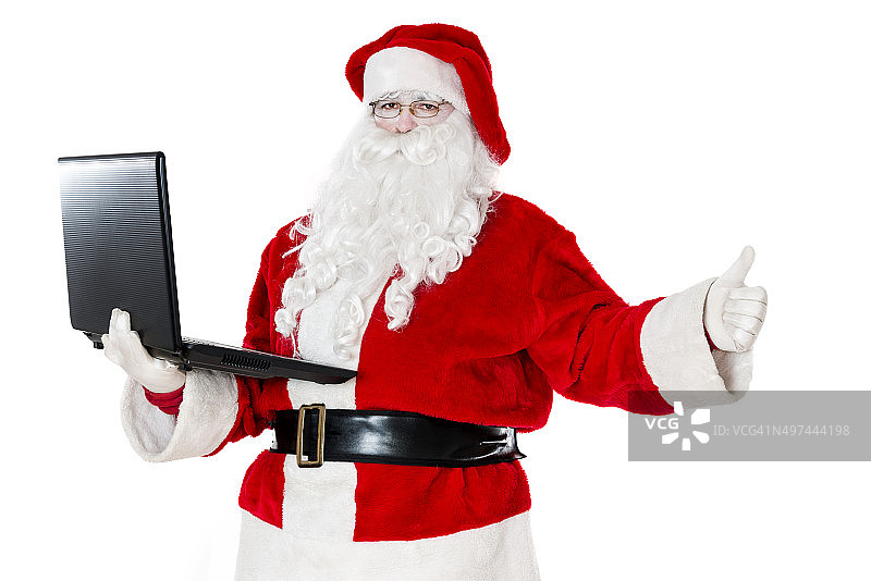 圣诞老人使用笔记本电脑和竖起大拇指图片素材