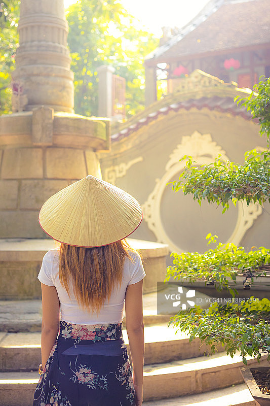 在亚洲的越南河内，年轻的越南妇女戴着传统的帽子图片素材