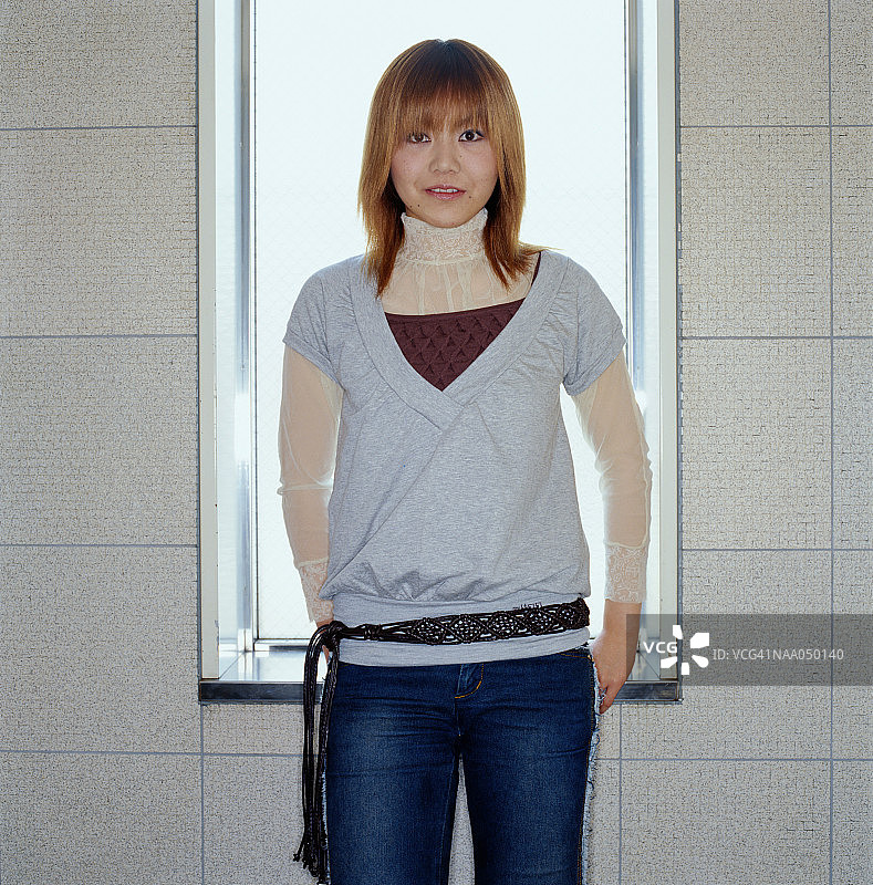 一个年轻女子站在窗前，画像图片素材