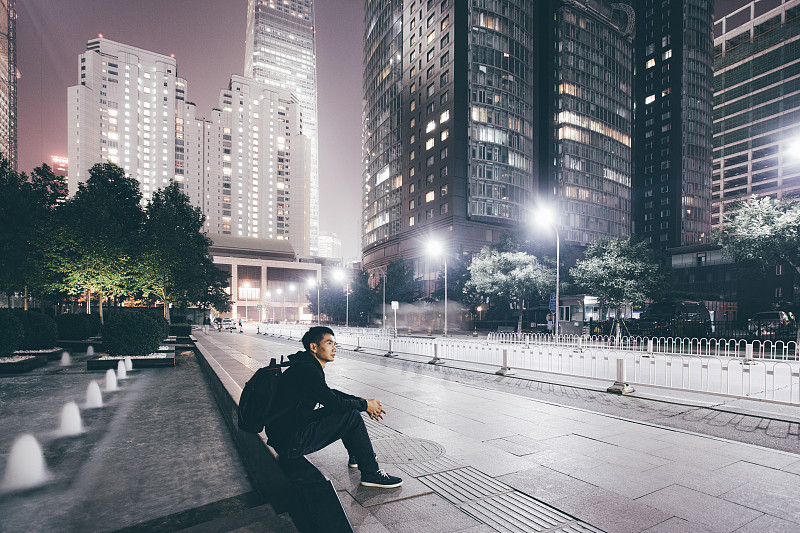 一个男人在城市之夜等待着什么图片素材