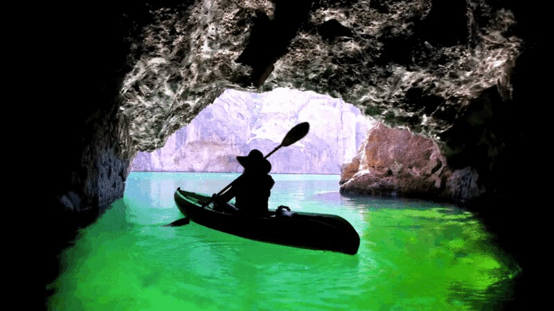 沿着河流的洞穴皮划艇的剪影图片下载