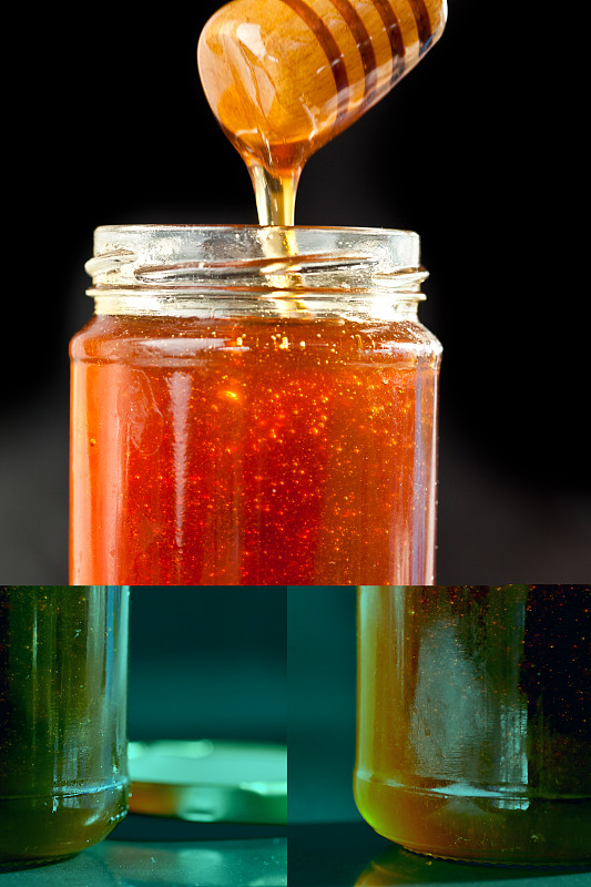 在黑色的背景下，蜂蜜粘稠地滴落在一个罐子里图片素材