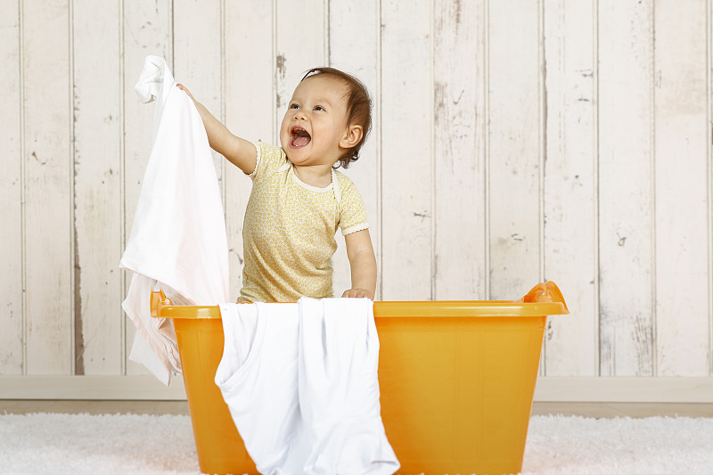小女孩站在洗衣篮里图片下载