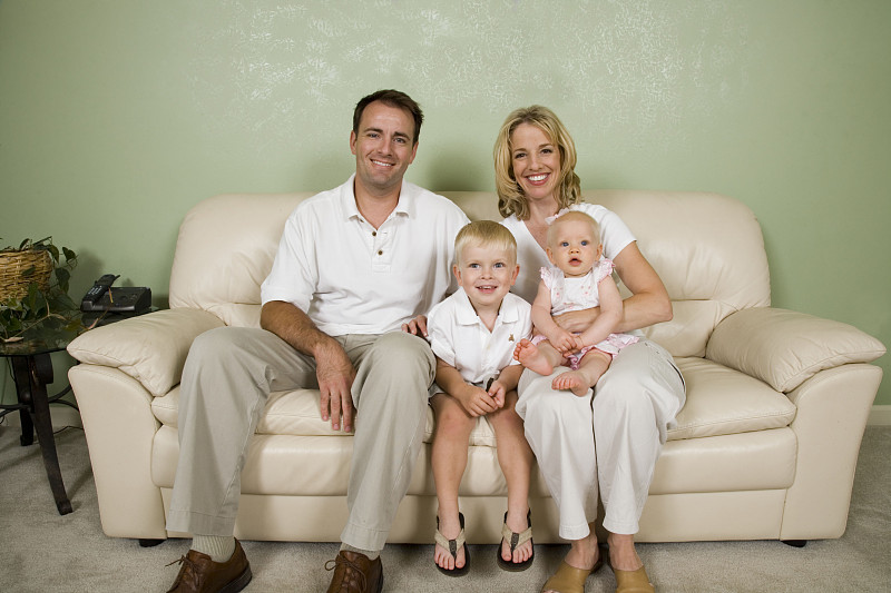 家庭照片，女儿(9个月)和儿子(4年)在沙发上摄影图片下载
