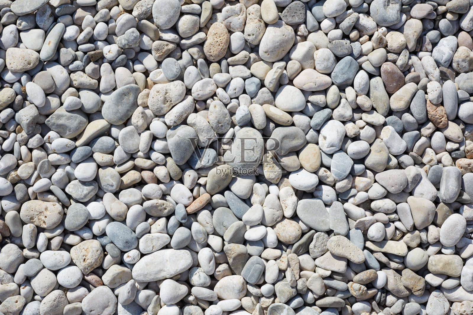 沙滩上的鹅卵石，抽象的石头背景照片摄影图片