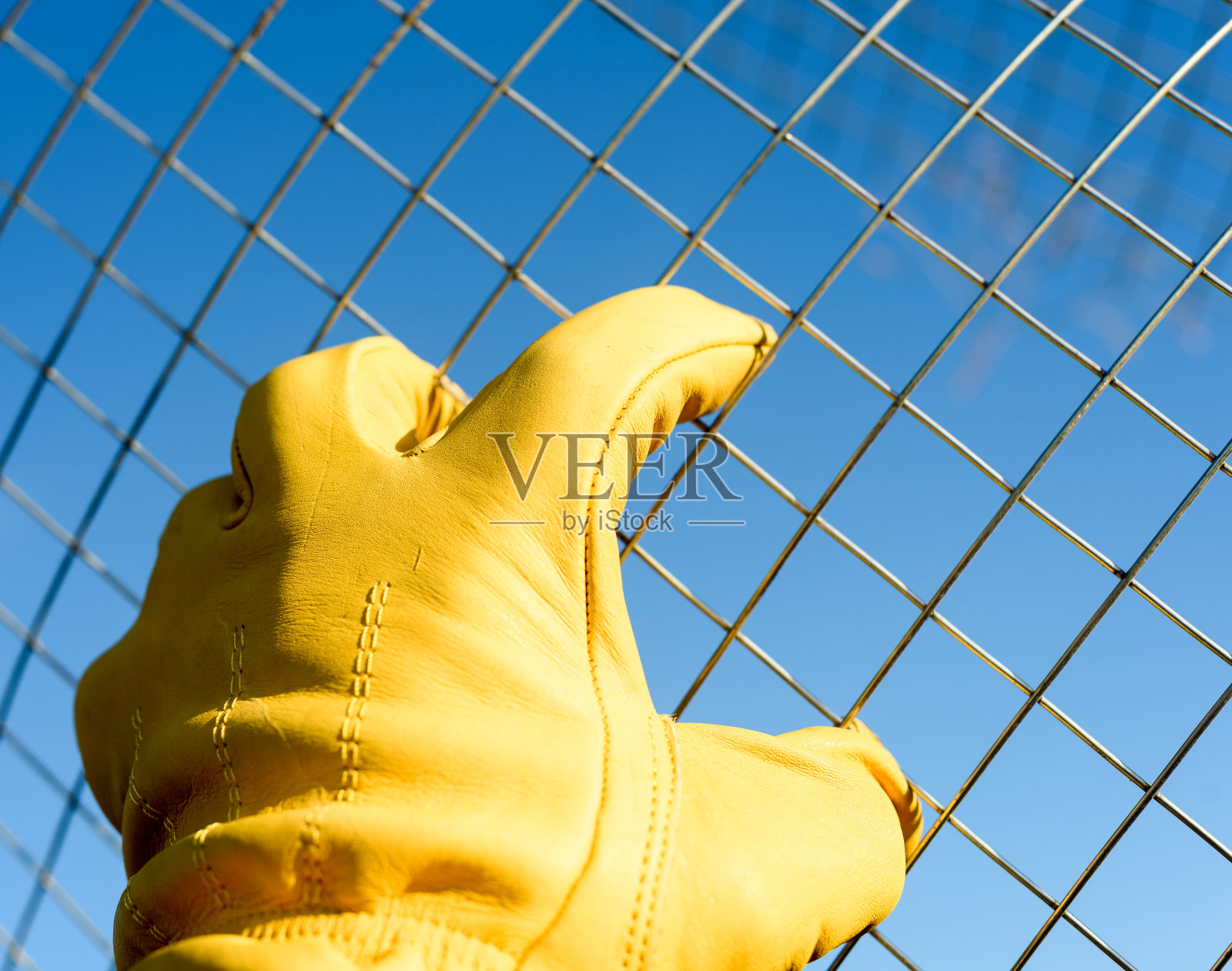 男性黄色手套手处理铁丝网照片摄影图片