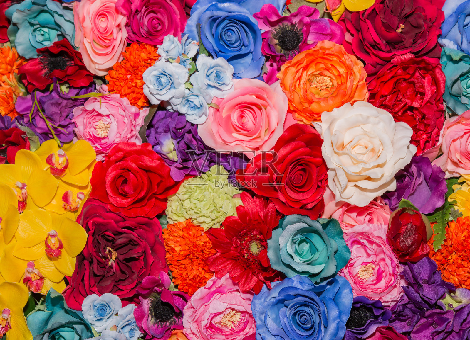 美丽的彩色人造花背景。照片摄影图片