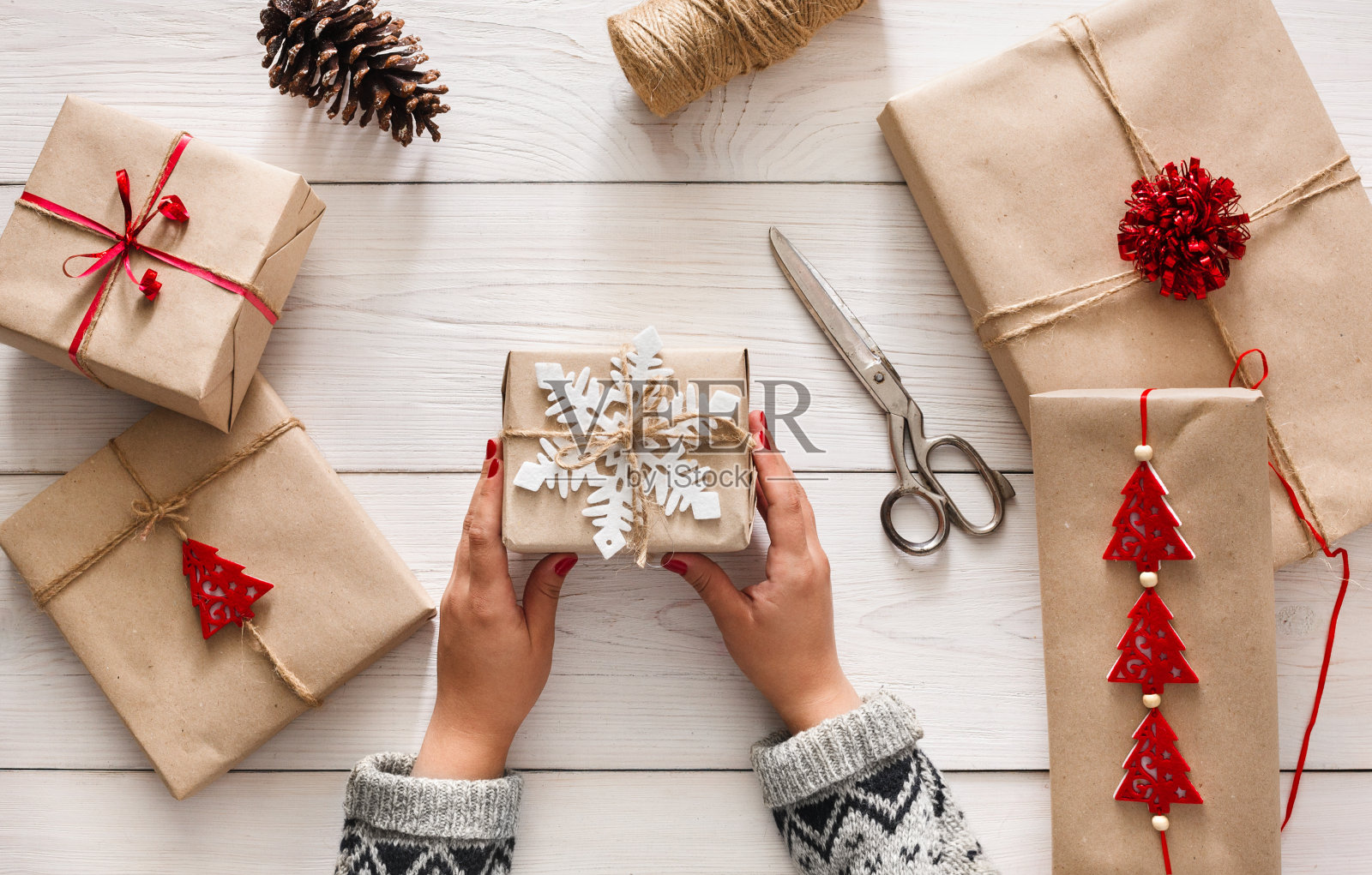 女人的手用手工麻线包裹圣诞礼物照片摄影图片