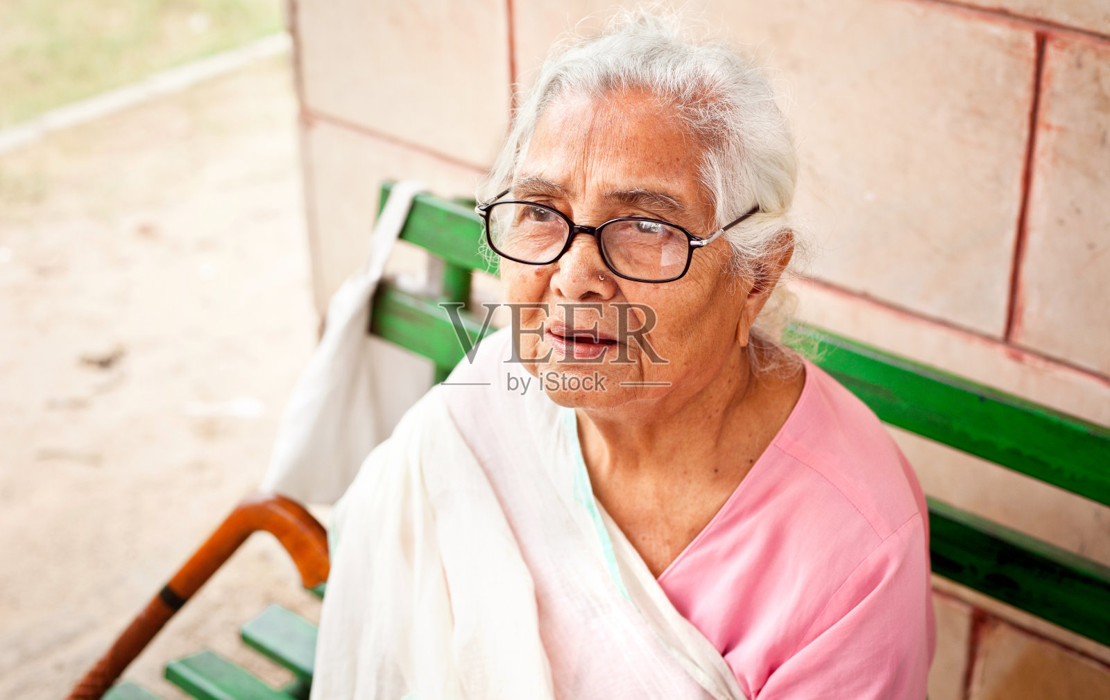 一位悲伤沉思的印度老妇人坐在户外照片摄影图片