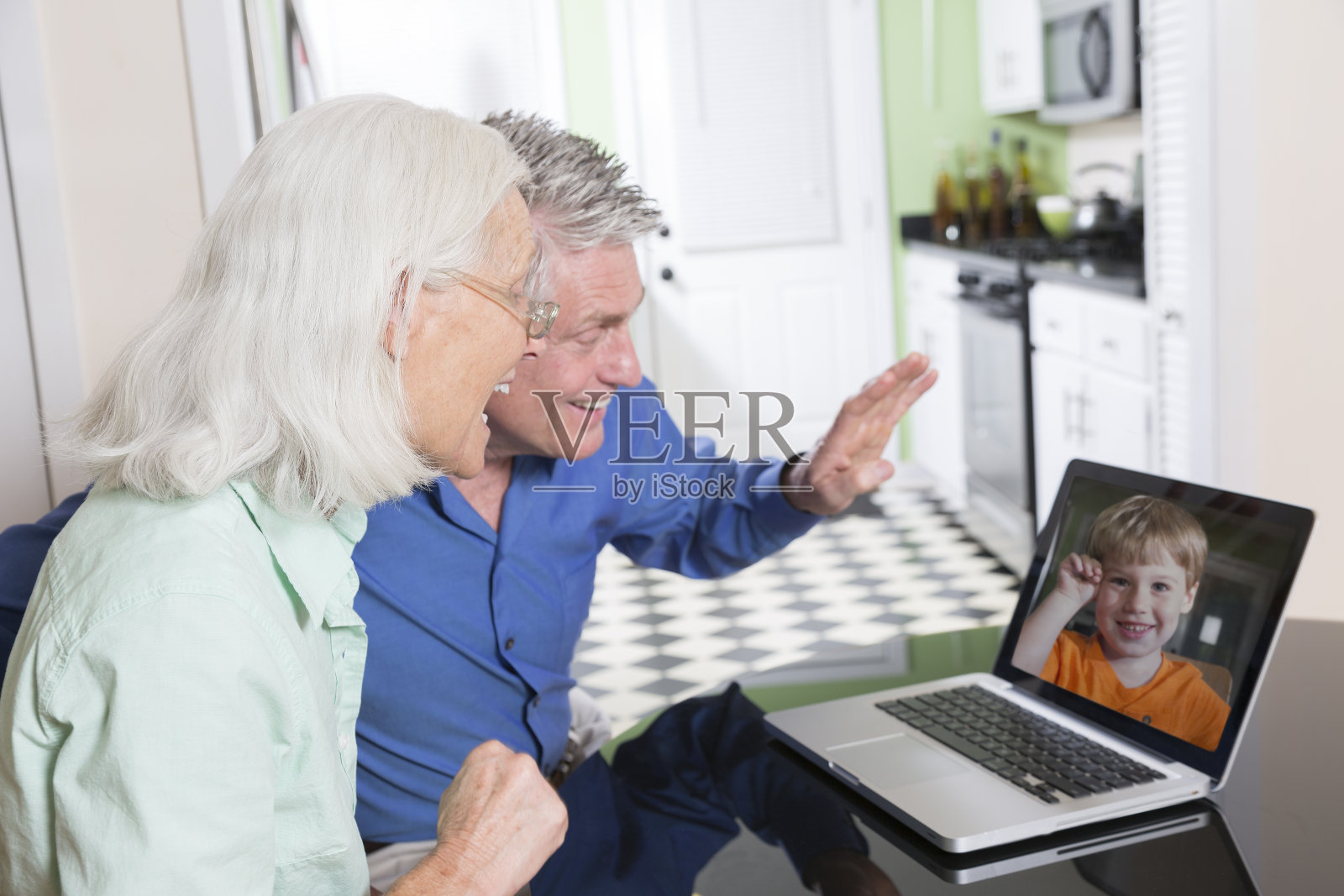 一对老夫妇在和孙子视频聊天照片摄影图片