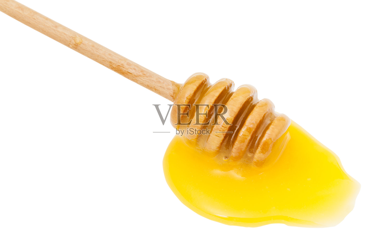 黄色的蜂蜜和木勺靠近照片摄影图片