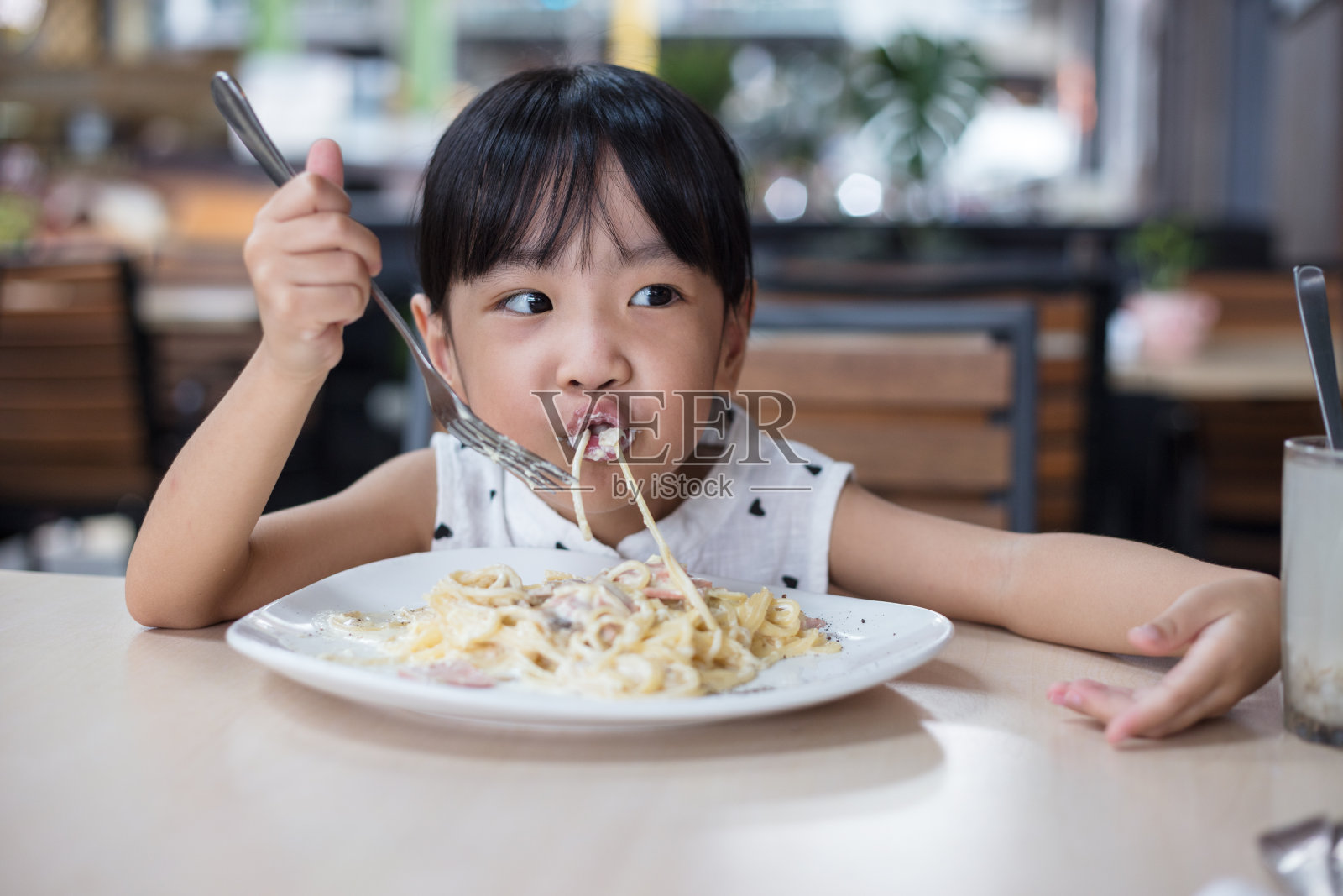 亚洲华人小女孩在吃意大利面照片摄影图片