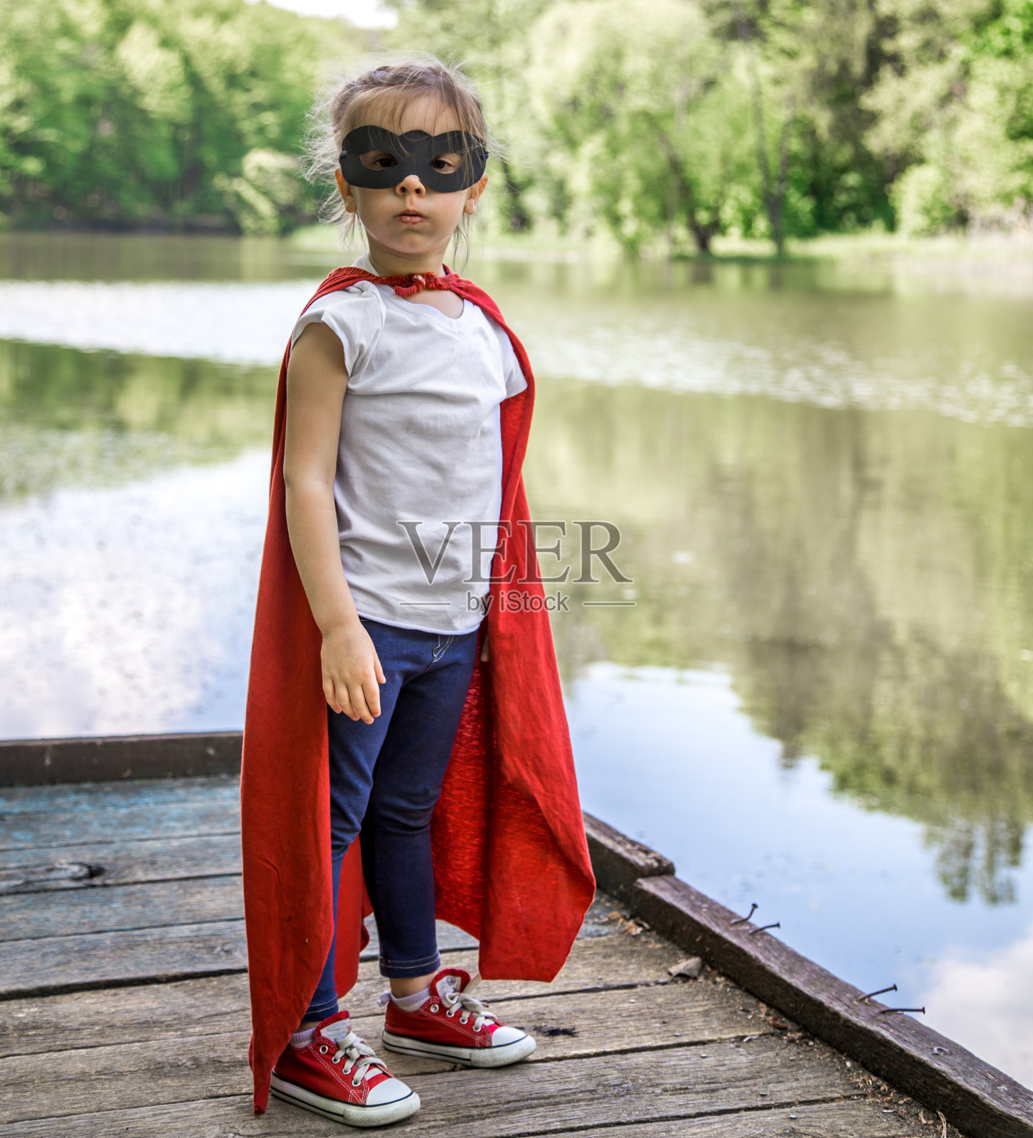 穿着超级英雄服装的可爱小女孩照片摄影图片