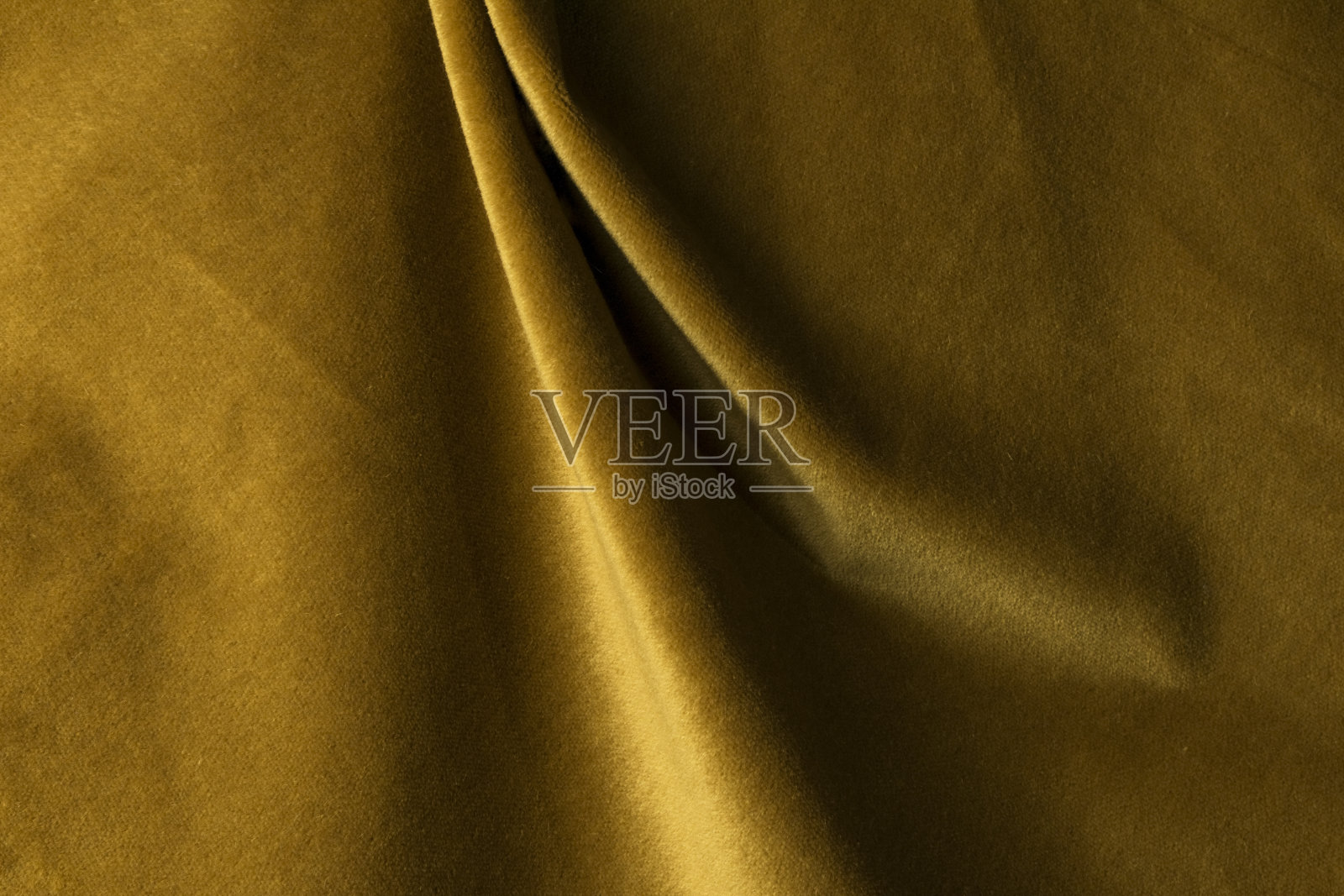 类似天鹅绒的金色安哥拉山羊丝绒织物，与天然丝线混纺。马海毛纺织。羊绒、天鹅绒、麂皮效果。为装饰照片摄影图片