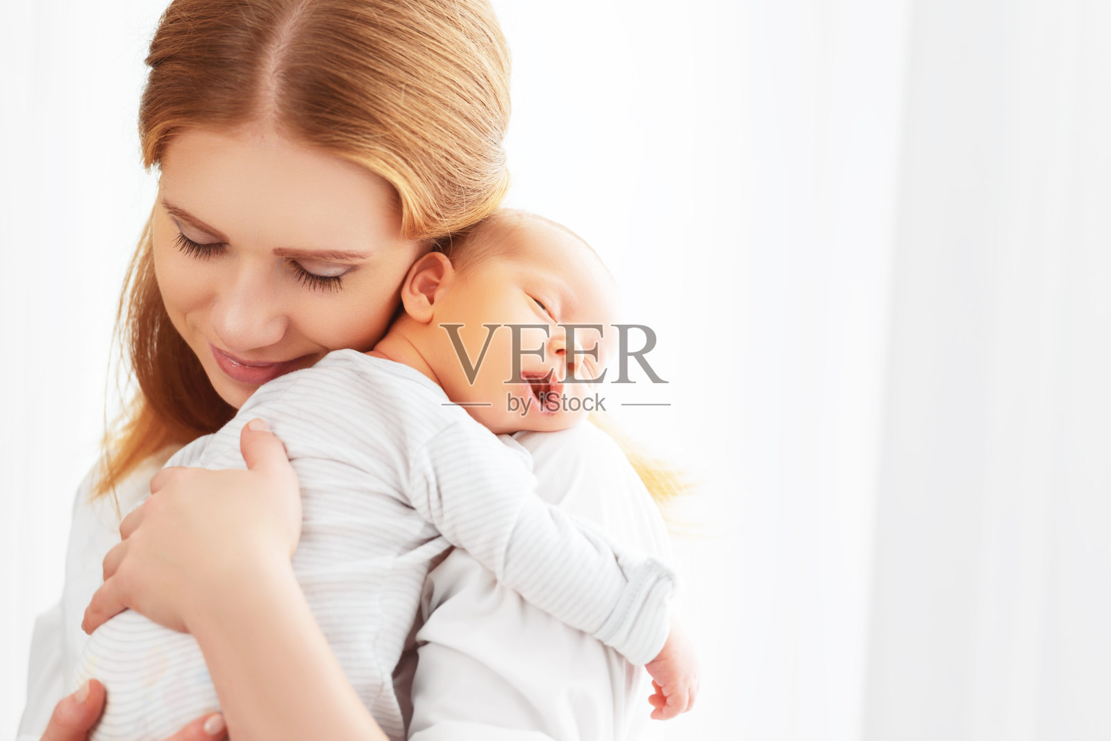 刚出生的婴儿在母亲温柔的怀抱中照片摄影图片