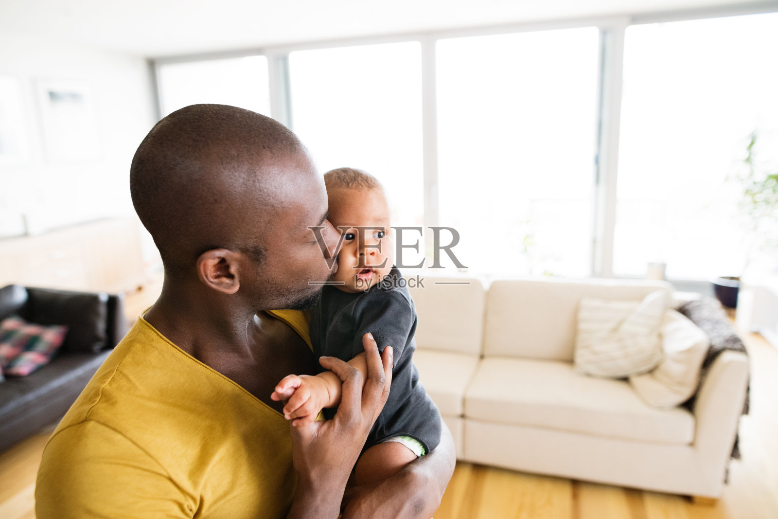 一位年轻的美国黑人父亲抱着他的小儿子照片摄影图片