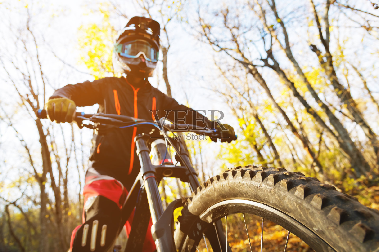 一个年轻骑手的肖像在充分保护一个完整的脸头盔面罩和手套在自行车上照片摄影图片