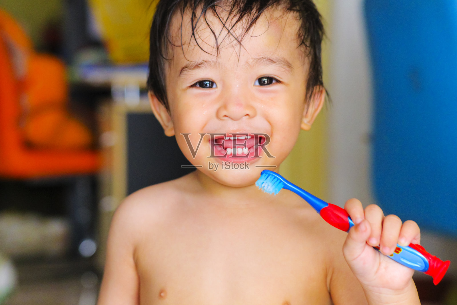 小男孩一边刷牙一边微笑照片摄影图片