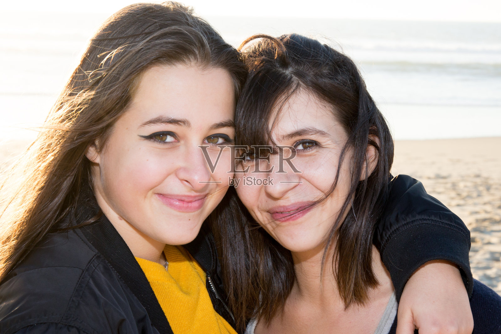 一个母亲和她女儿在海滩上的肖像照片摄影图片