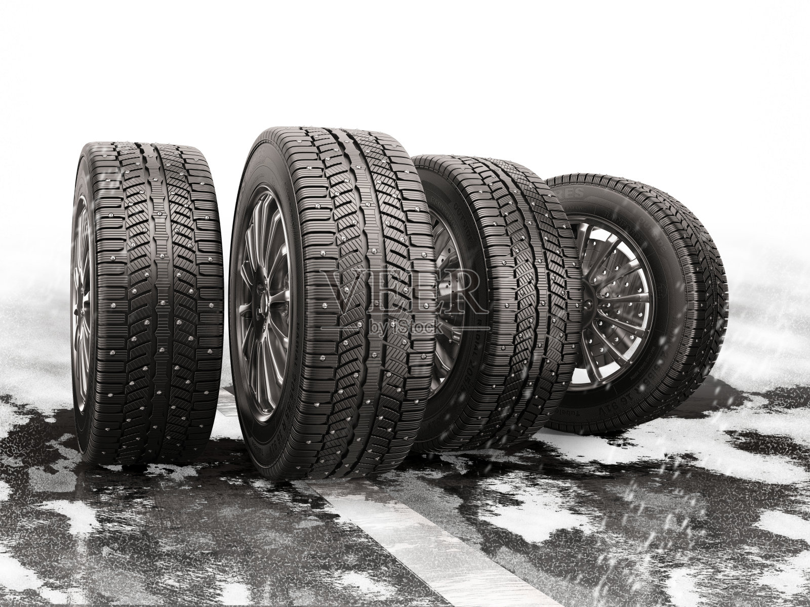 四个汽车轮胎在积雪覆盖的道路上滚动。照片摄影图片