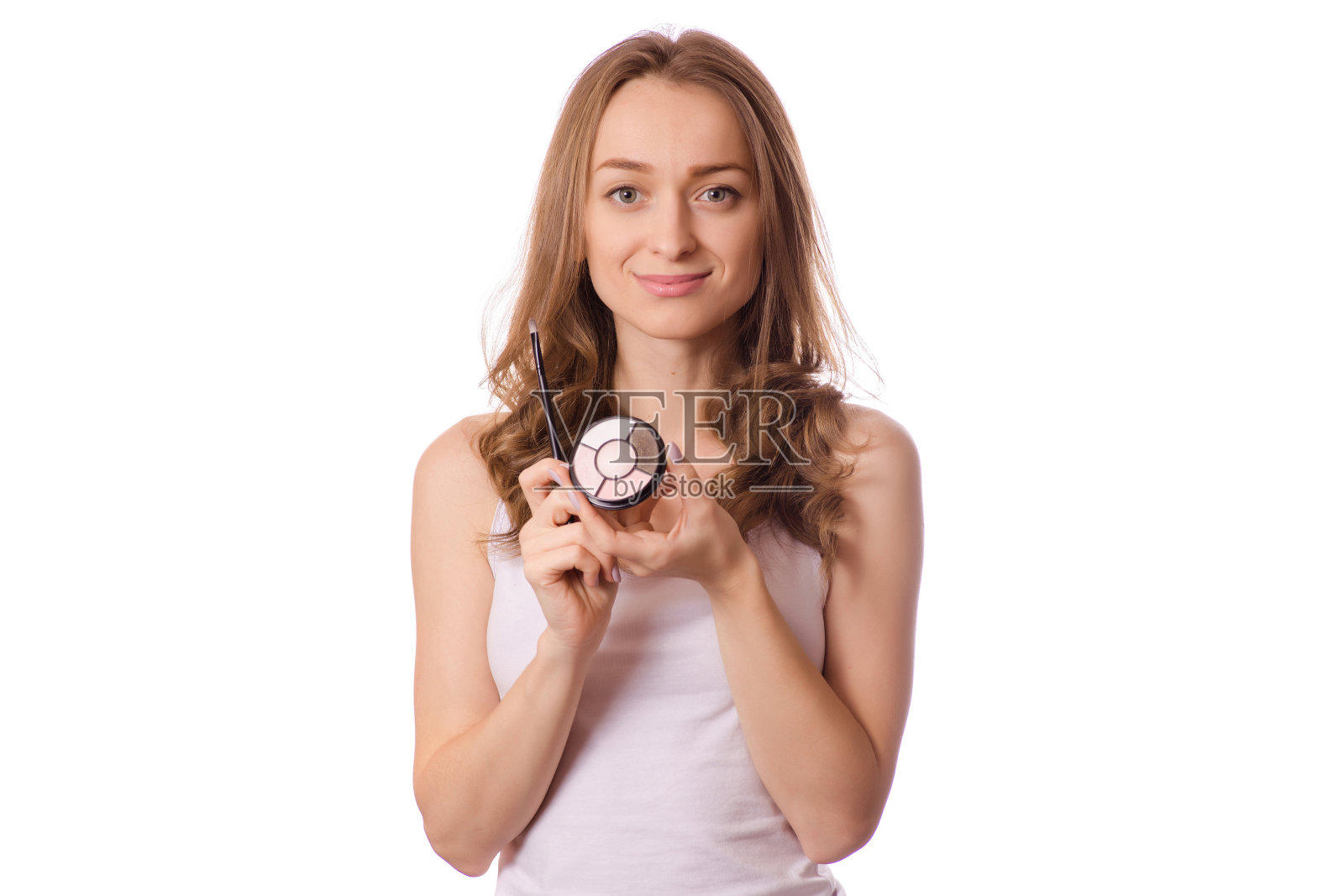 漂亮的年轻女子眼影和化妆刷照片摄影图片