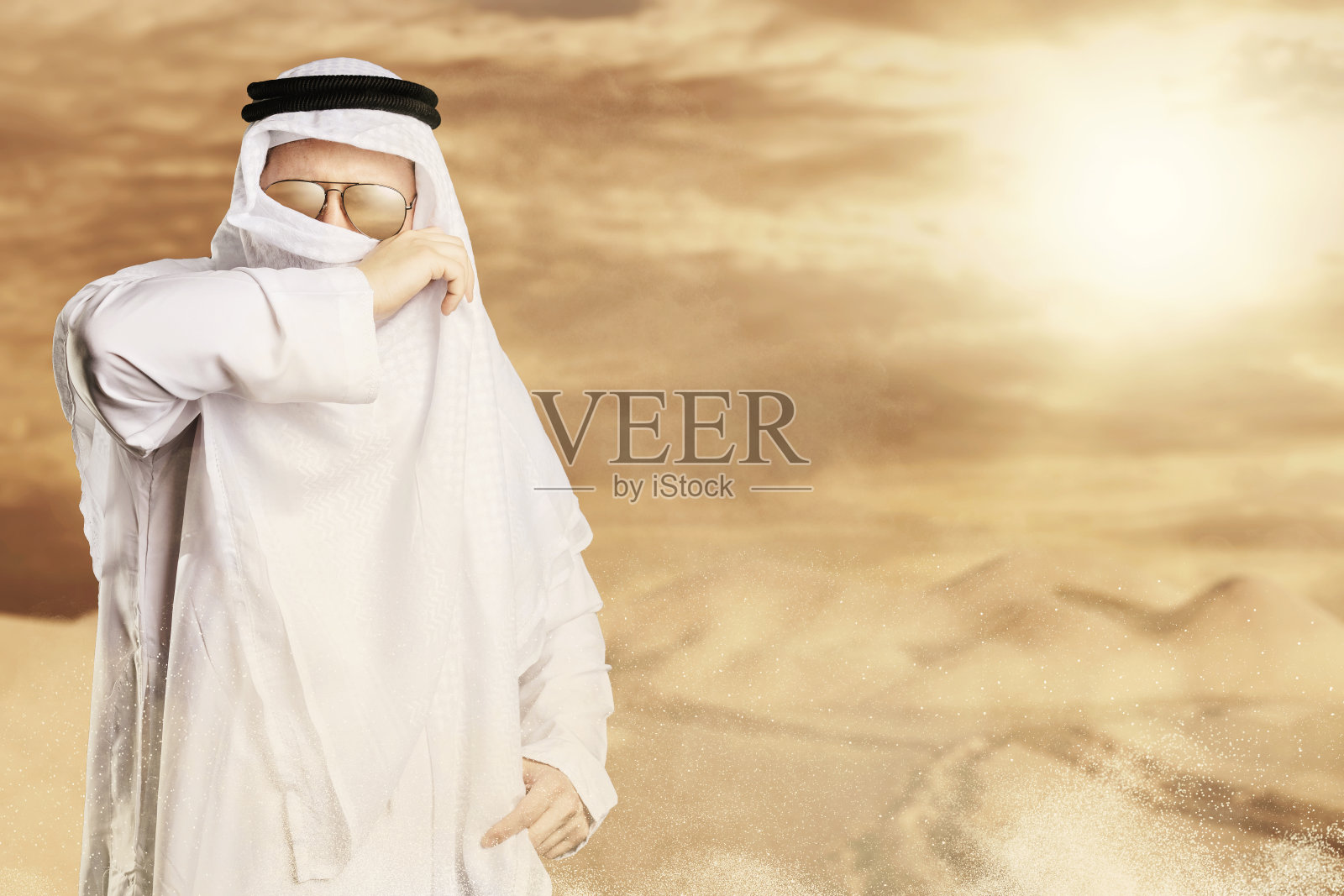 Sheik用keffiyeh在阳光下保护沙漠风暴照片摄影图片