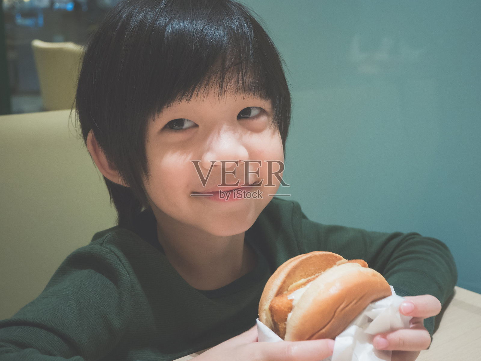 亚洲女孩在餐馆吃汉堡包照片摄影图片