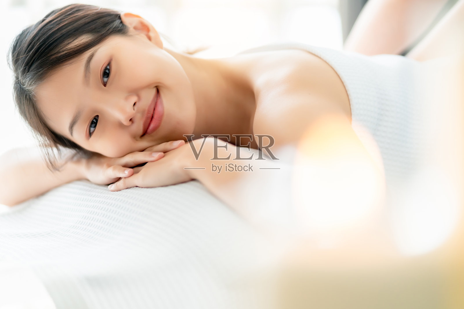 美丽的亚洲女人按摩温泉与幸福放松面部健康的护肤概念，晨光天照片摄影图片