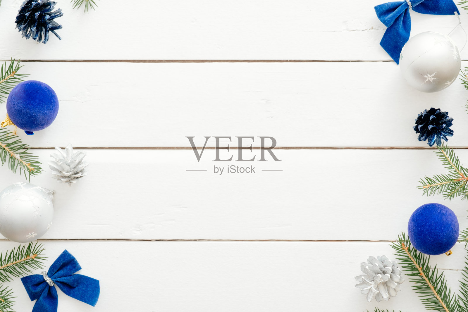 圣诞框架与蓝色的球，冷杉树枝，礼盒，装饰品在木制的白色背景。新年假期节日横幅模型。圣诞贺卡模板。平躺，俯视图，头顶。插画图片素材