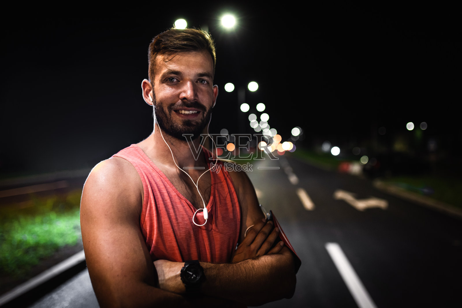 年轻的健身男子站在路上准备夜间跑步的肖像。照片摄影图片