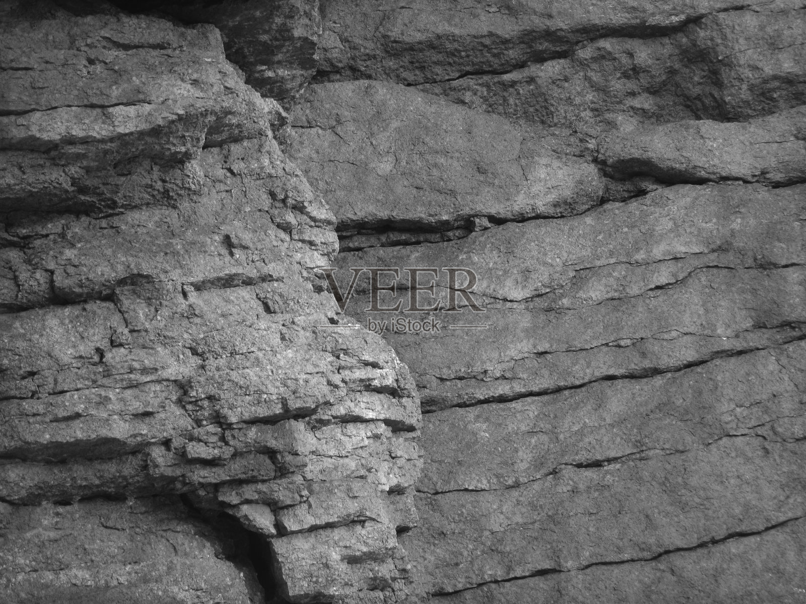 枯燥乏味的灰色背景。岩石纹理。一个山的碎片特写。石头的背景。照片摄影图片