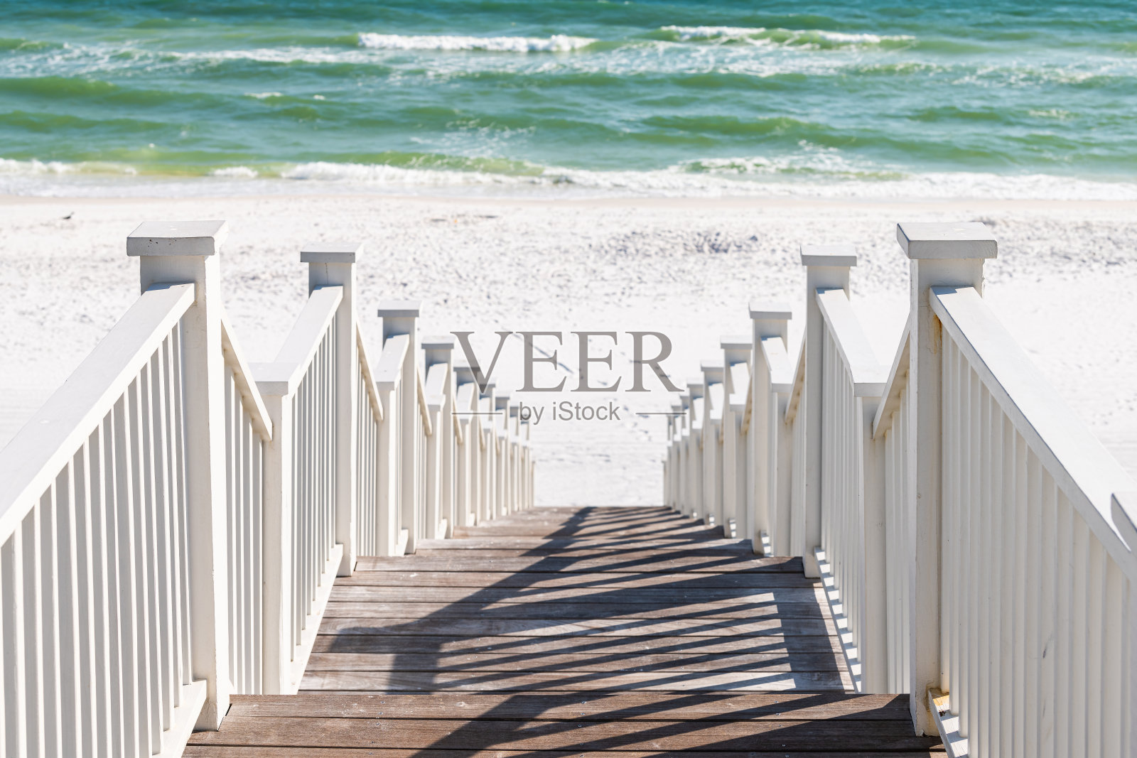 海边，佛罗里达的栏杆木制亭子，步道建筑由海滩海洋背景视图下来在阳光明媚的日子照片摄影图片