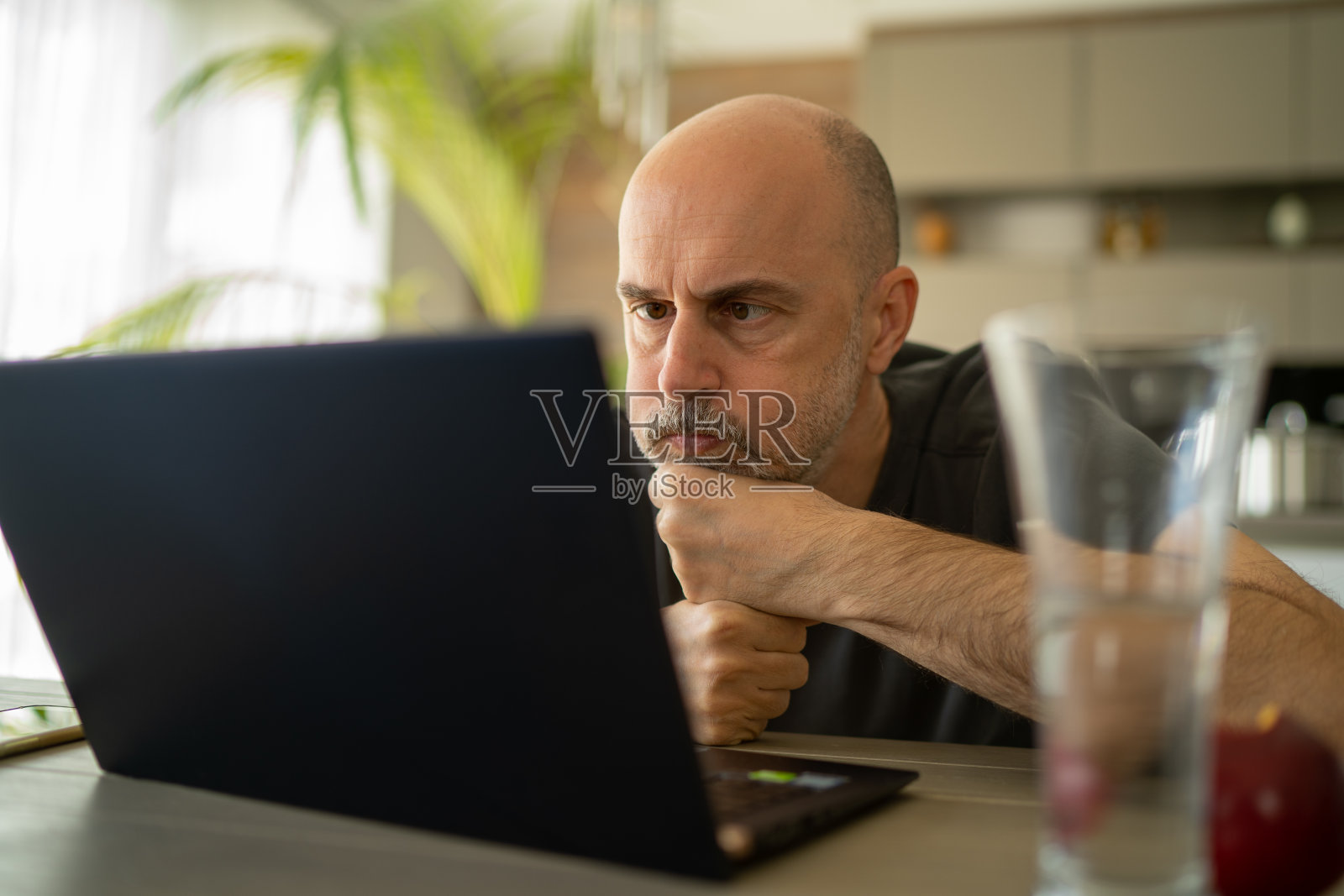 忧心忡忡的商人经理在冠状病毒危机期间在家使用笔记本电脑工作照片摄影图片