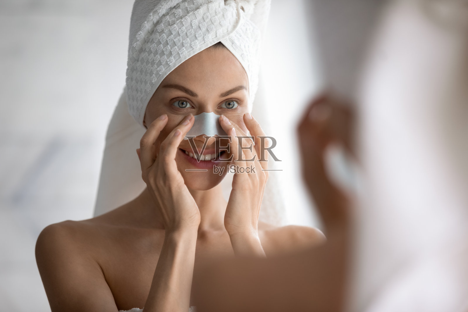 快乐的女士享受家庭皮肤护理的早晨例行程序。照片摄影图片