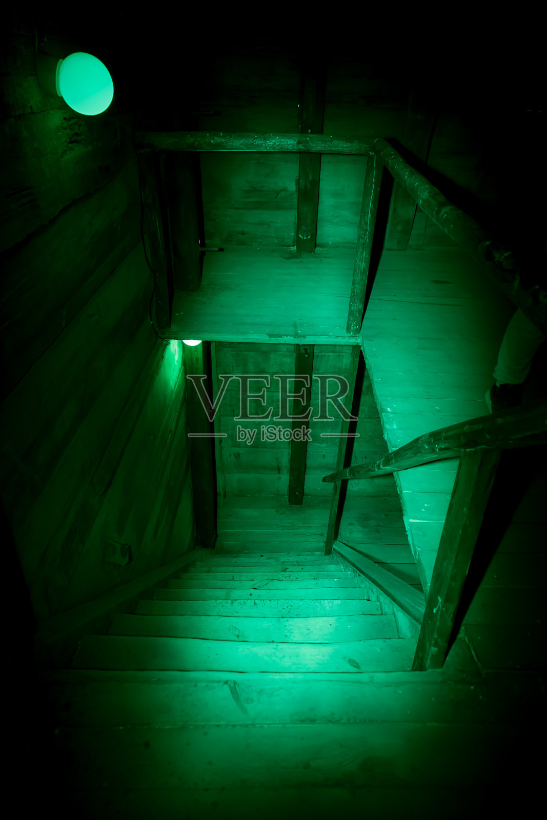神秘恐怖的阁楼背景万圣节。古色古香的肮脏的木制楼梯在黑暗中神秘诡异的地下室或阁楼在绿光下有黑色的影子插画图片素材