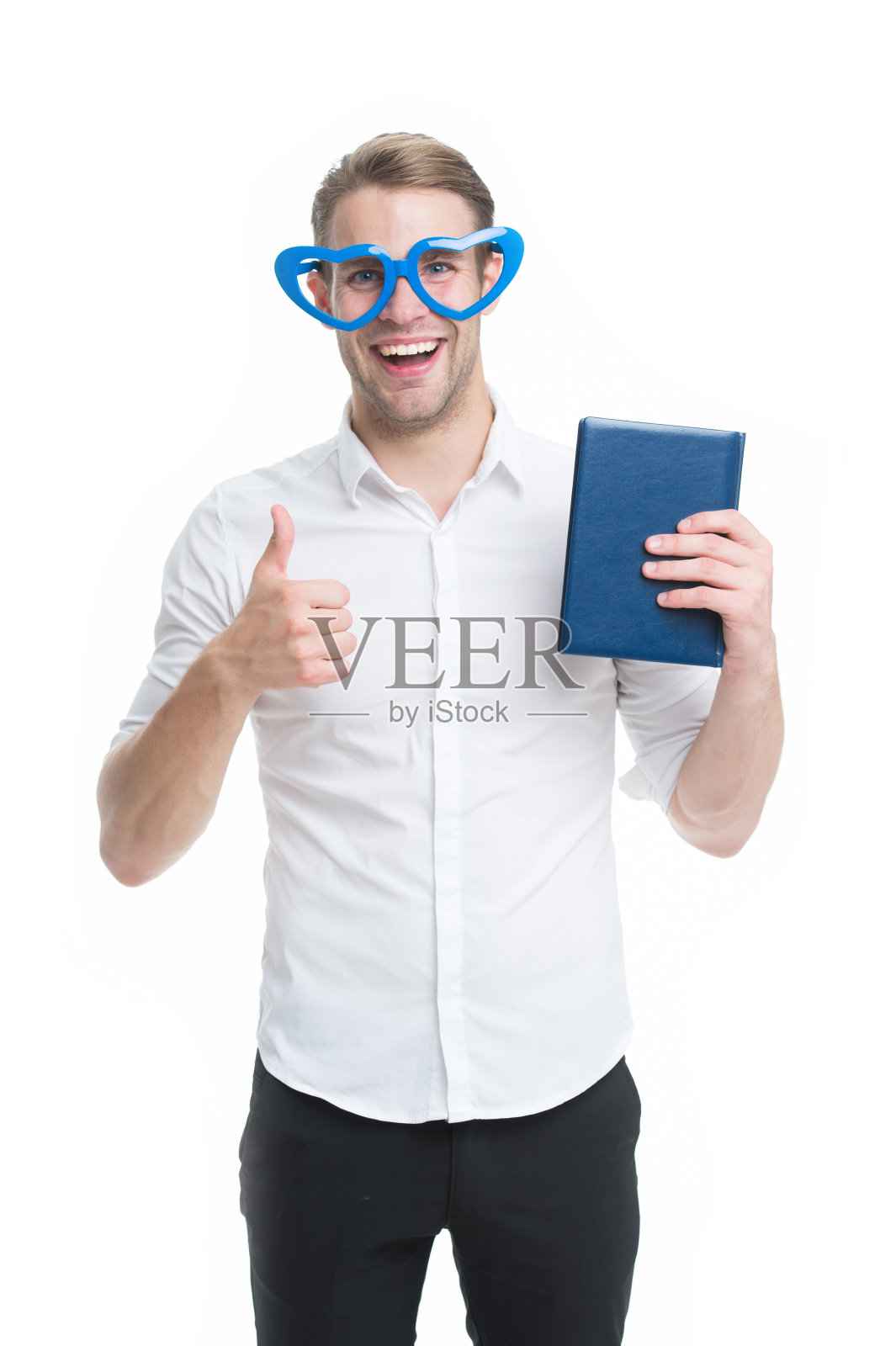 我喜欢读书。戴着心形眼镜的书呆子喜欢读书。男人拿着书，竖起大拇指，孤立的白色。我每天至少读几页书。我最喜欢的书照片摄影图片