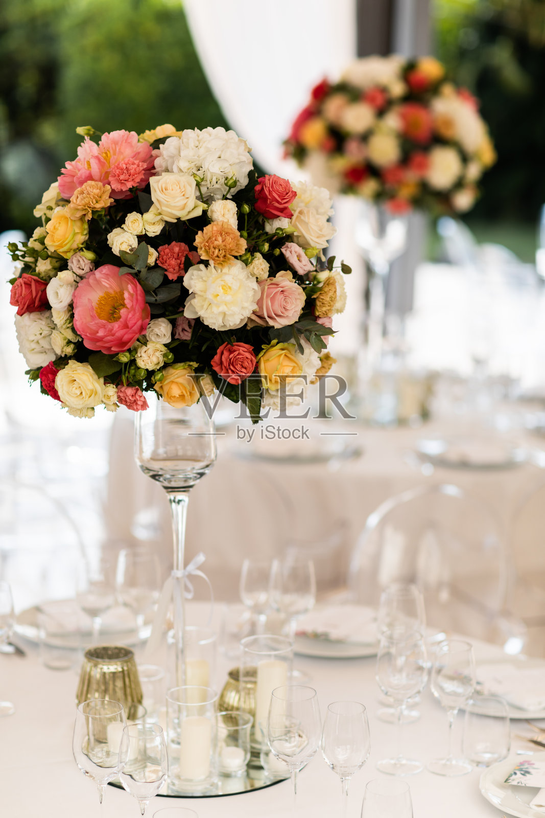宴会桌装饰以棉花和鲜花组成，酒杯和盘子都摆在桌上照片摄影图片