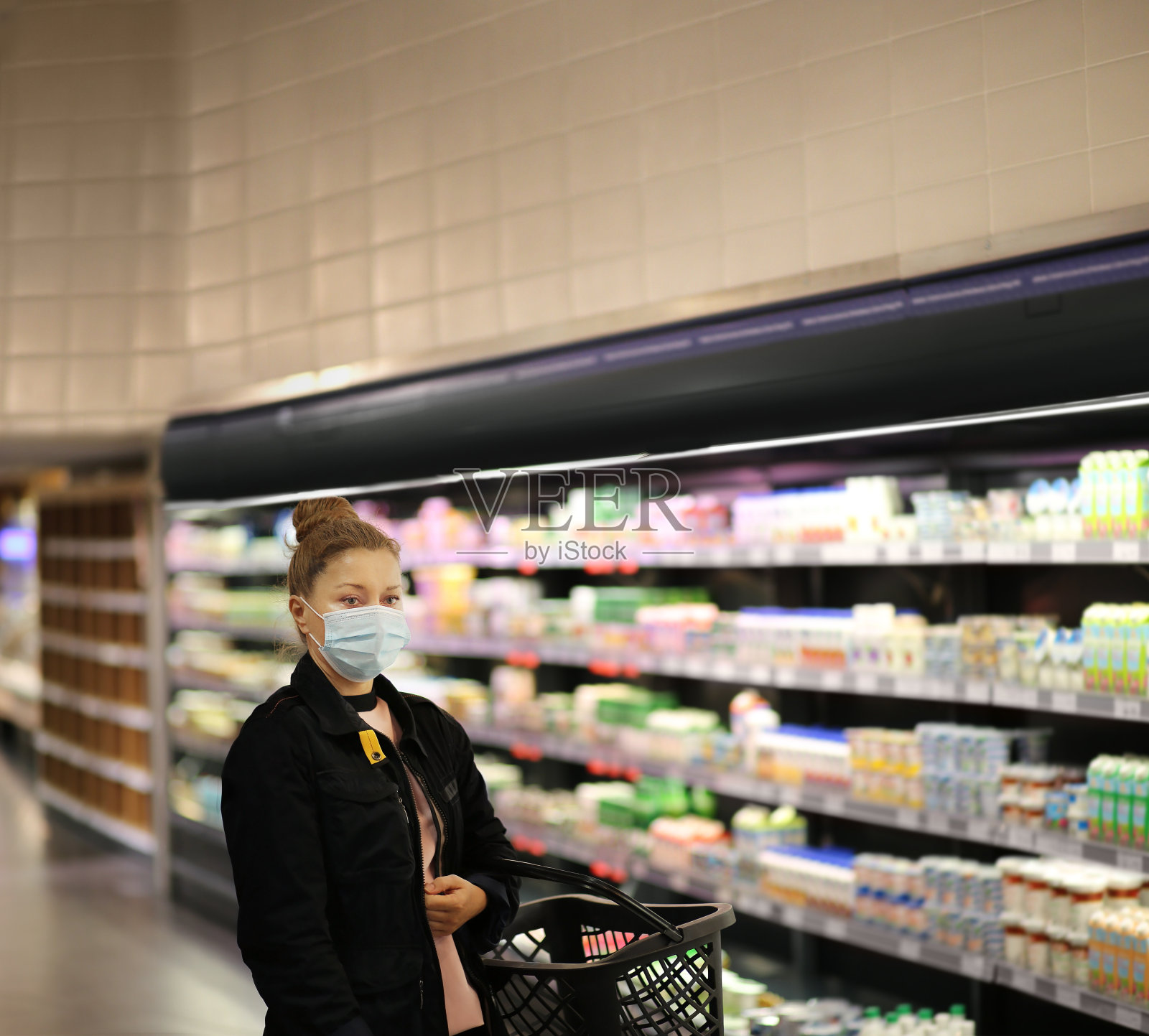 女人在超市购物阅读产品信息。照片摄影图片