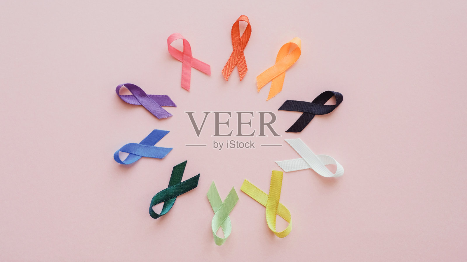 粉色背景的彩带，癌症意识，世界癌症日，国家癌症幸存者日，世界自闭症意识日照片摄影图片