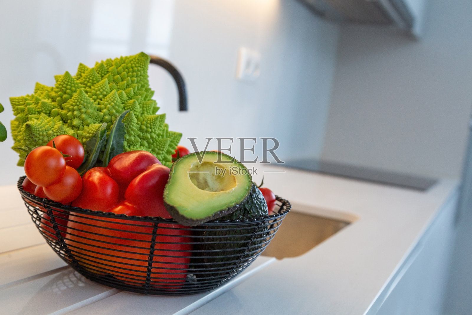 公寓白色厨房里的新鲜蔬菜。照片摄影图片