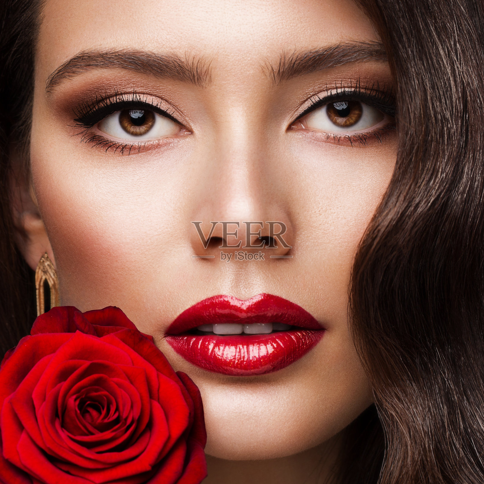 美女脸红唇画像与玫瑰。时尚模特女孩红唇妆。豪华皮肤护理化妆品和化妆接近照片摄影图片