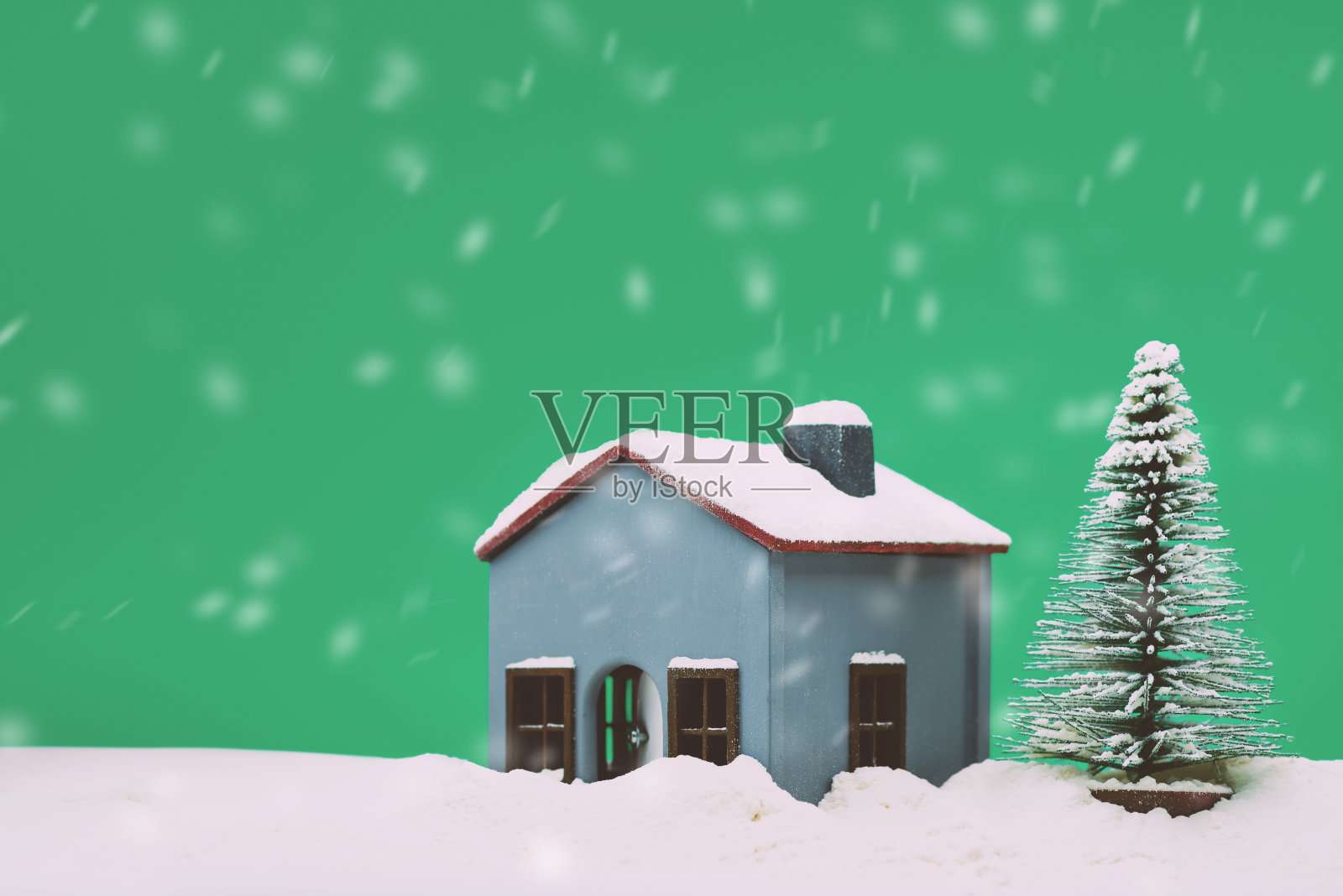 模型房子和一棵有雪的松树照片摄影图片