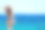 美丽的年轻女子站在希腊的海岸上看着大海素材图片